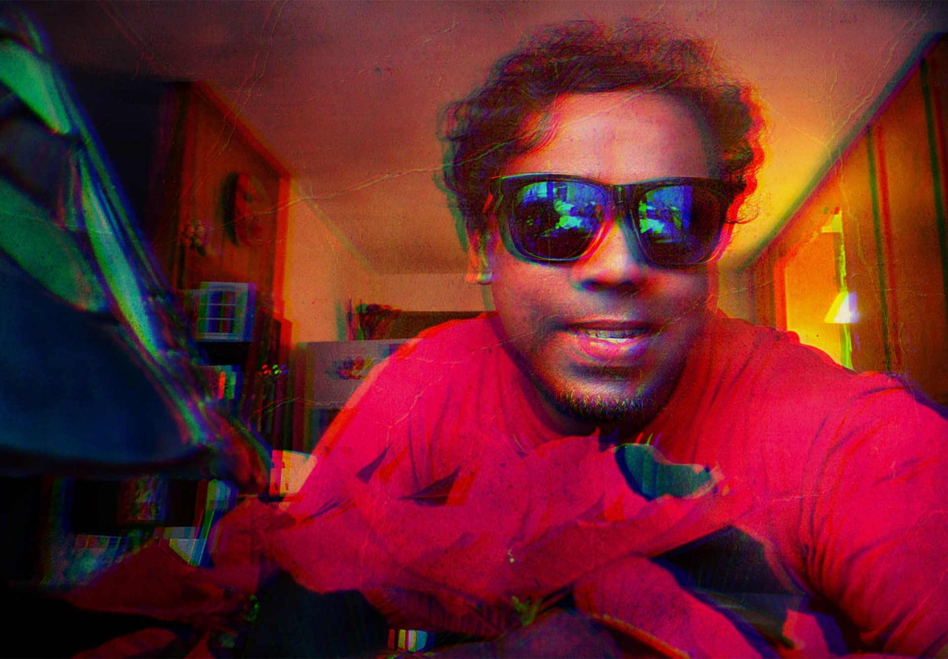Anaglyph 3D glitch self-portrait with red-cyan channel split and a poinsettia in the foreground